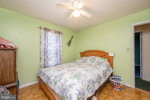 bedroom featuring a textured ceiling, light parquet floors, and ceiling fan