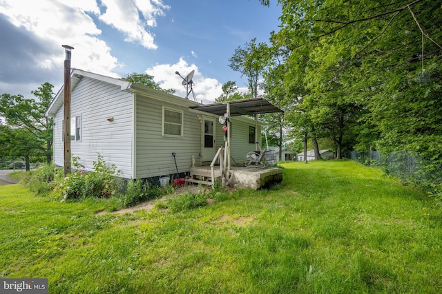 rear view of property with a yard