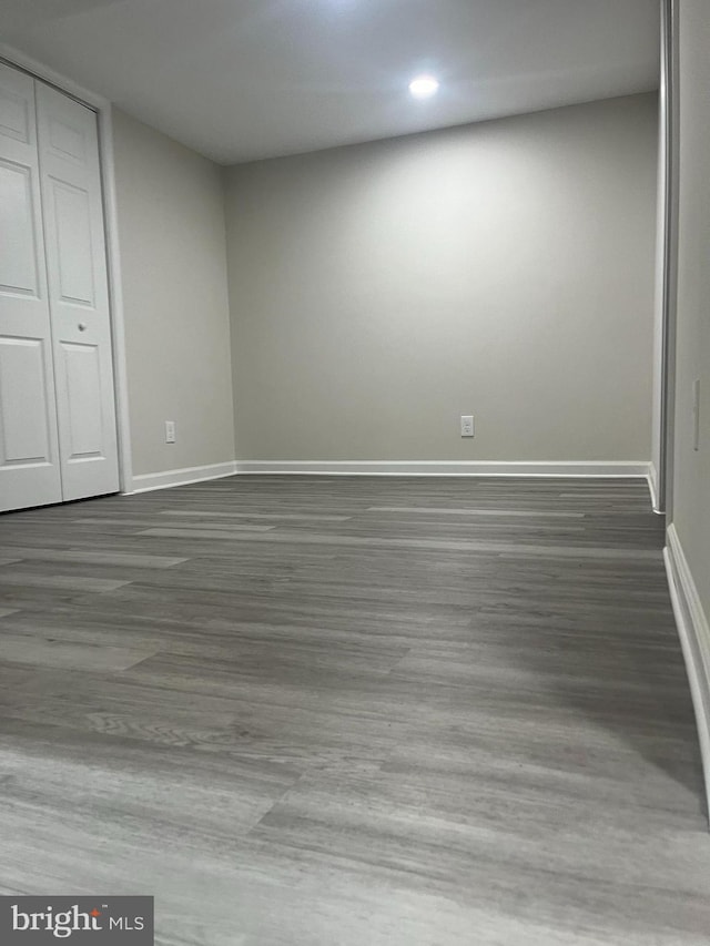 unfurnished bedroom featuring a closet and dark hardwood / wood-style floors