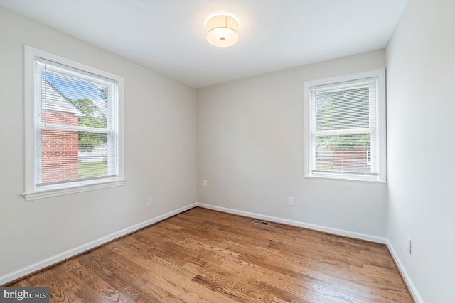 spare room featuring hardwood / wood-style floors