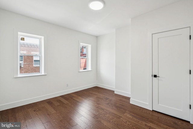 spare room with dark hardwood / wood-style flooring