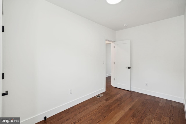 spare room featuring dark hardwood / wood-style floors