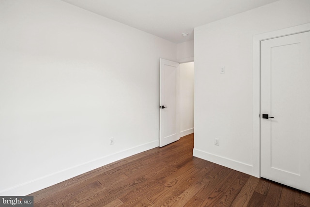 unfurnished bedroom with dark hardwood / wood-style flooring