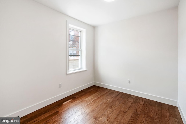 unfurnished room with hardwood / wood-style flooring