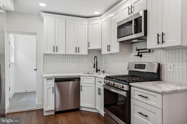 kitchen with white cabinetry, sink, dark wood-type flooring, and appliances with stainless steel finishes