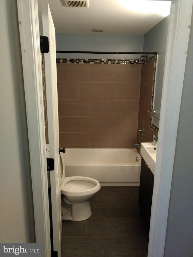 full bathroom with tile patterned flooring, vanity, toilet, and tiled shower / bath