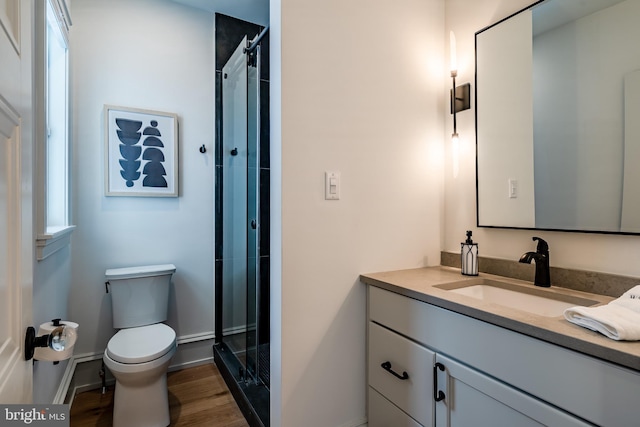 bathroom featuring hardwood / wood-style flooring, vanity, toilet, and plenty of natural light