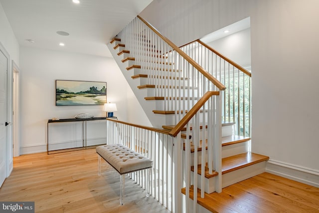 stairs with hardwood / wood-style flooring