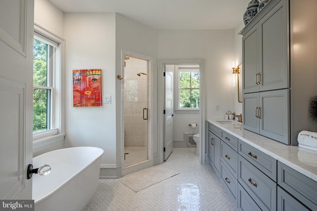 full bathroom featuring tile patterned floors, plenty of natural light, separate shower and tub, and toilet