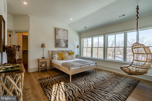 bedroom with wood-type flooring and lofted ceiling