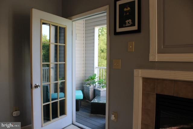 doorway to outside with a fireplace