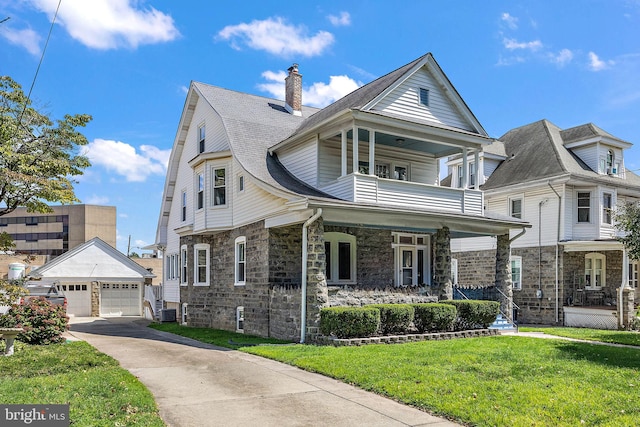 view of front of home with an outdoor structure, a front yard, a balcony, a garage, and a porch