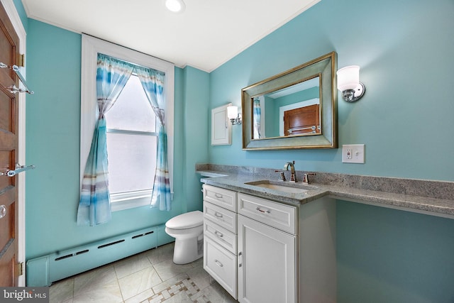 bathroom with tile patterned floors, vanity, toilet, and a baseboard heating unit