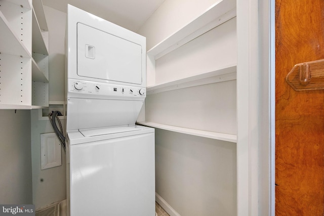 laundry area featuring stacked washer / dryer