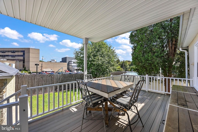 wooden terrace featuring a lawn