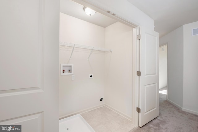 clothes washing area with electric dryer hookup, light colored carpet, and washer hookup