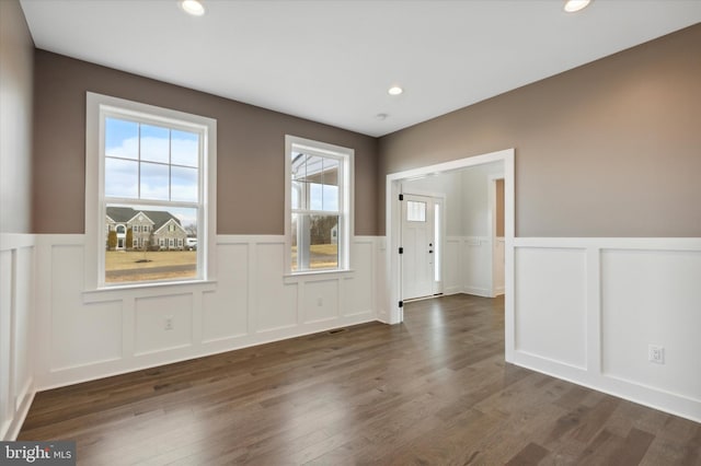 unfurnished room with dark hardwood / wood-style floors