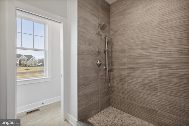 bathroom with tiled shower