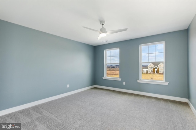 empty room with carpet and ceiling fan