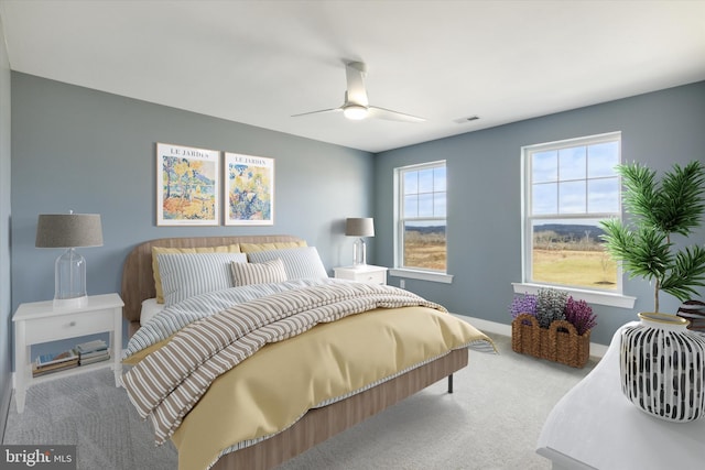 bedroom featuring ceiling fan and light colored carpet