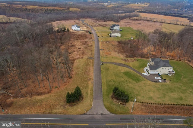 birds eye view of property with a rural view