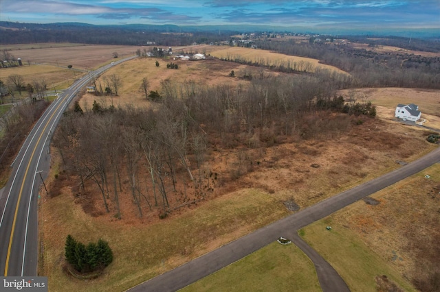 aerial view at dusk featuring a rural view