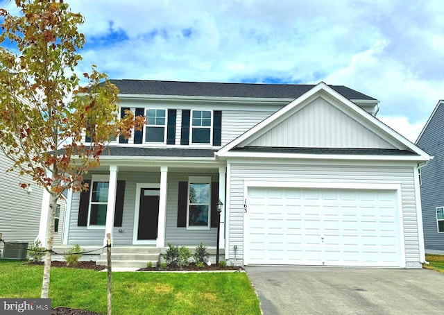 view of front of house featuring central AC unit, a garage, and a front lawn