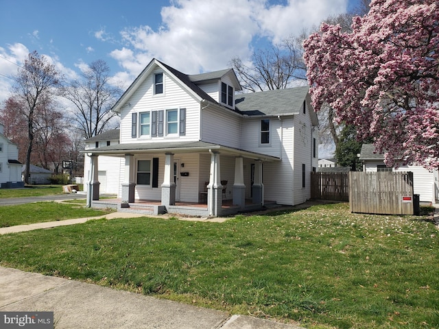 view of front of property featuring covered porch and a front yard