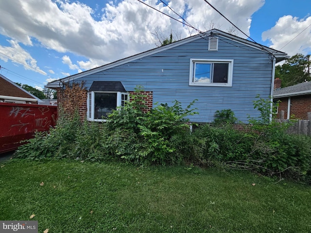 view of side of home featuring a lawn