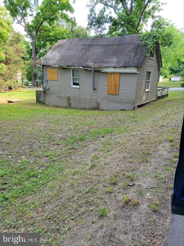 view of side of property with a yard