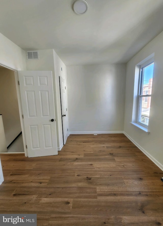 spare room with dark hardwood / wood-style floors