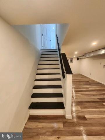 stairway with wood-type flooring