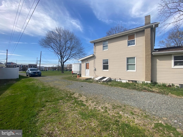 view of property exterior featuring a lawn