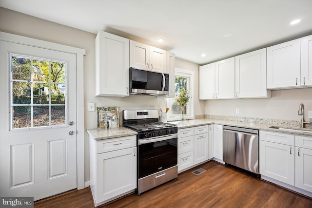 kitchen with white cabinetry, appliances with stainless steel finishes, a healthy amount of sunlight, and sink