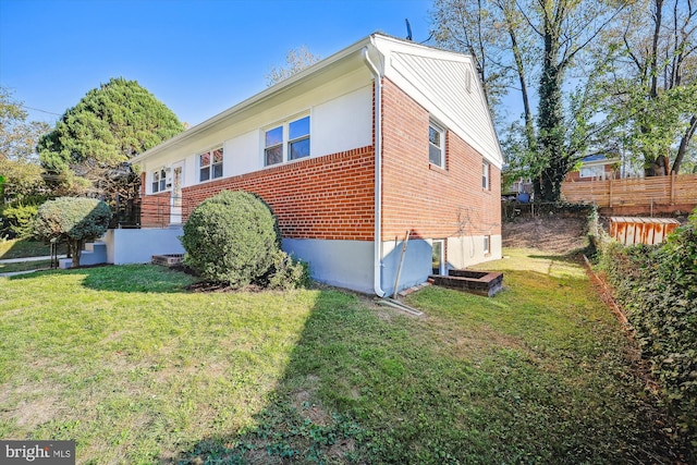 view of side of property featuring a yard