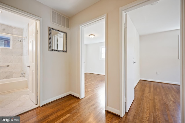 hallway featuring wood-type flooring