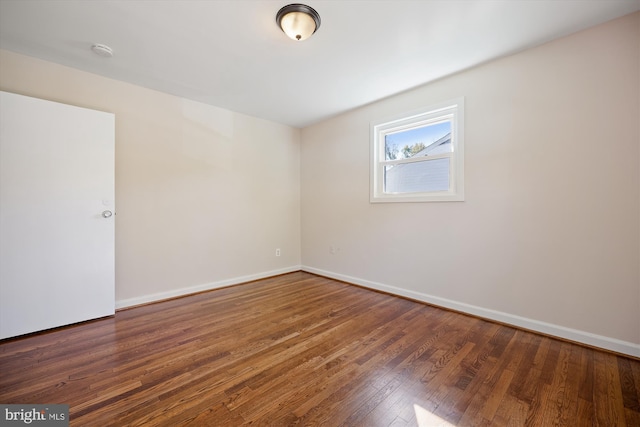 empty room featuring dark wood-type flooring