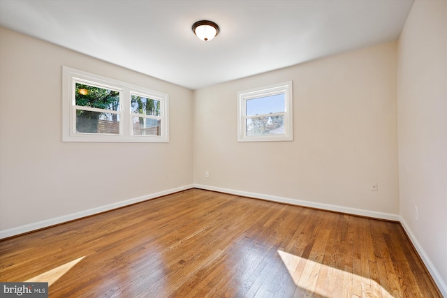 unfurnished room with a wealth of natural light and light hardwood / wood-style flooring