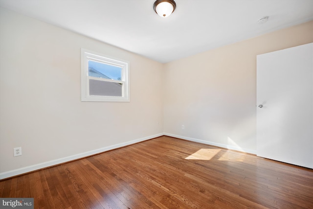 unfurnished room with wood-type flooring