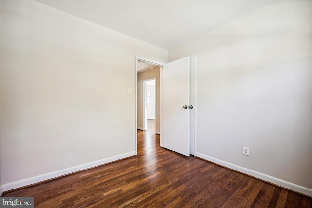 spare room with dark hardwood / wood-style floors