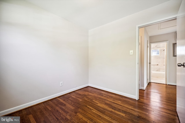 unfurnished room with dark hardwood / wood-style floors