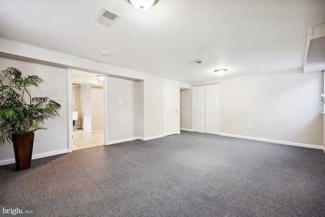 unfurnished room featuring light carpet