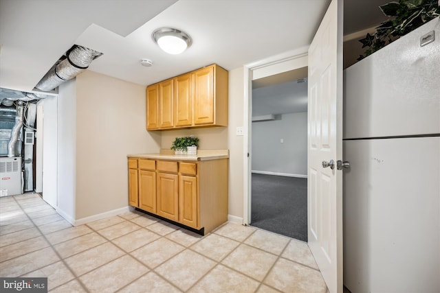 kitchen featuring light brown cabinetry and light tile patterned floors