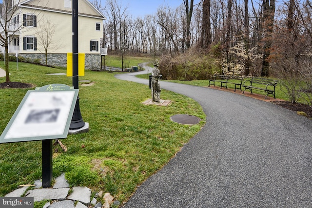 view of property's community with a lawn