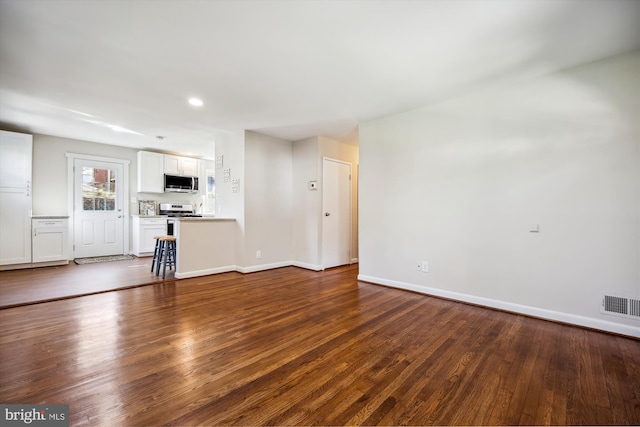 unfurnished living room featuring dark wood-type flooring