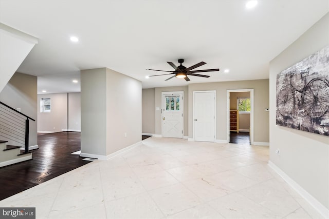 interior space with recessed lighting, stairway, plenty of natural light, and a ceiling fan