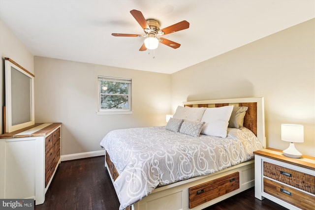 bedroom with dark wood-style flooring, baseboards, and ceiling fan