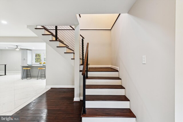 staircase featuring wood-type flooring, ceiling fan, baseboards, and recessed lighting
