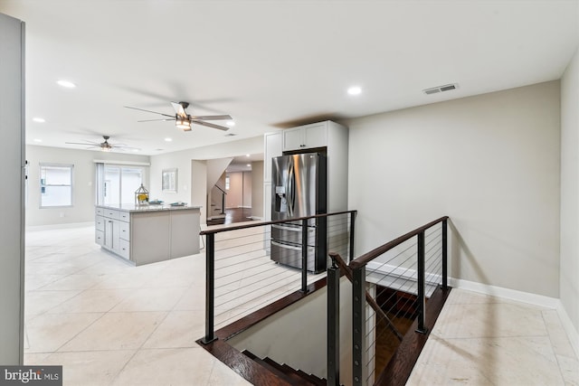 stairway with tile patterned flooring, a ceiling fan, visible vents, recessed lighting, and baseboards