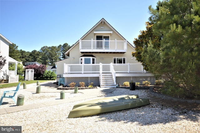 view of front of home with a balcony and a deck